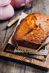 Homemade Banana Bread Cake Loaf on wooden backdrop on table background, top view, copy space for text