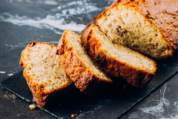 Homemade Sliced Banana Bread Cake on wooden backdrop on table background, top view, copy space for text