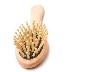 Wooden comb on a white background. Free space for text