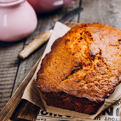 Homemade Banana Bread Cake Loaf on wooden backdrop on table background, top view, copy space for text