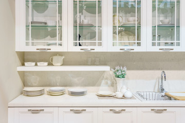 Modern kitchen furniture with contemporary kitchenware like faucet and sink in house.