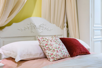 Bed maid-up with clean white pillows and bed sheets in beauty room, Close-up.
