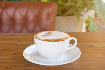 cappuccino in white coffee cup on wood table, coffee time