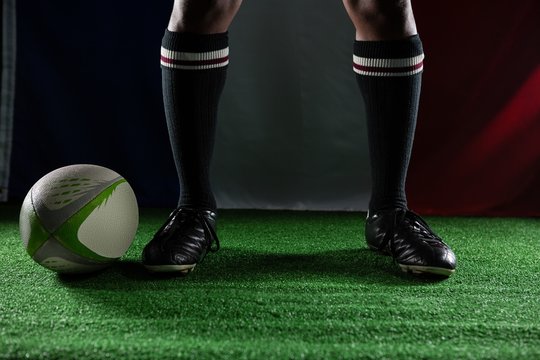 Low section of rugby player standing against Italian Flag - Powered by Adobe