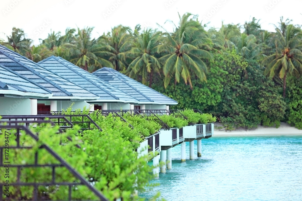 Sticker view of modern beach houses on piles at tropical resort