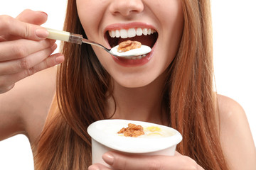 Young woman eating yogurt, closeup