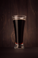 Weizen beer glass porter or red ale on dark wood board,vertical. Template for advertising, design, branding identity, restaurant menu, cover.