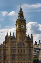 Fototapeta na wymiar Vertical isolated view of the famous Big Ben Clock Tower in London, England against perfect fluffy clouds.