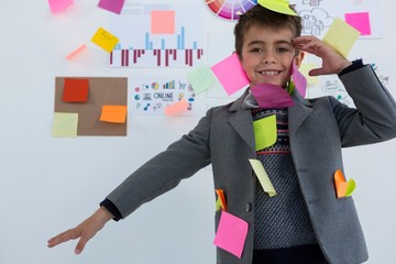 Boy as business executive with sticky notes on his body - Powered by Adobe