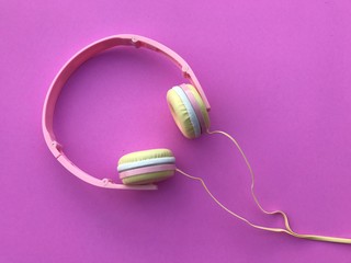 Closeup A colorful headphone on pink background. Colorful gadgets on pink background. Top view with Copy space. Selective focus.H