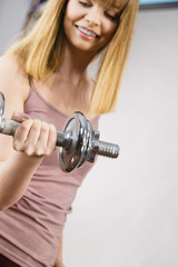 Woman working out at home with dumbbell