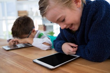 Boy as business executive using digital tablet