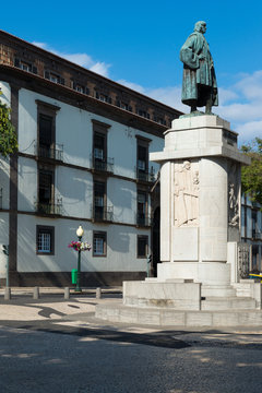FUNCHAL, MADEIRA, PORTUGAL - SEPTEMBER 9, 2017: Joao Gon&ccedil;alves Zarco statue in front of the bank of Portugal