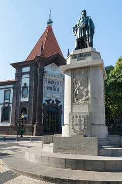 FUNCHAL, MADEIRA, PORTUGAL - SEPTEMBER 9, 2017: Joao Gon&ccedil;alves Zarco statue in front of the bank of Portugal