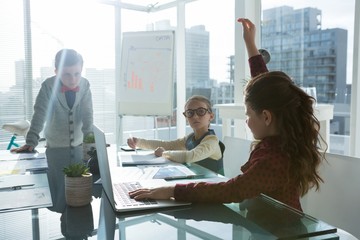 Kids as business executives interacting while meeting