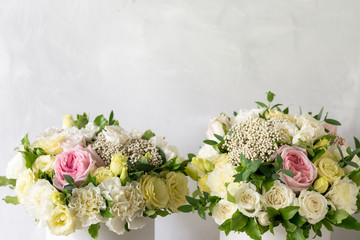 Beautiful tender bouquet of flowers in white box on light ackground with space for text