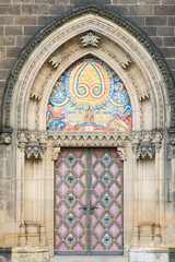 Fototapeta na wymiar Prague, Czech Republic - August 21, 2017: Colored entrance door of San Lawrence Basilica