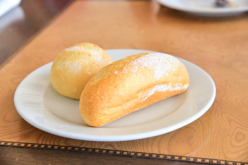 French Baguette and Bread Roll Isolated on White Plate