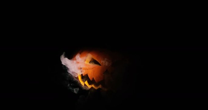 Shining Jack-O-Lantern. Halloween pumpkin with scary face isolated on the black background