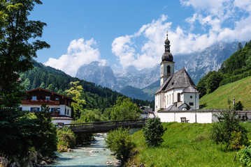 Fototapeta na wymiar Scenic view of small white church against mountains
