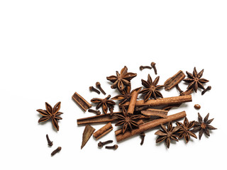 Winter spices background. Cinnamon, cloves and star anise with copy space. Isolated on white with clipping path. Top view or flat lay. Winter food background concept.