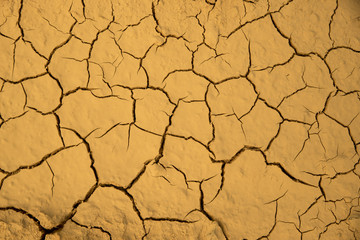 Dried cracked earth soil ground texture background. Mosaic pattern of sunny dried earth soil