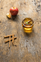 hot apple juice in glass with cinnamon on old wood. autumn food concept