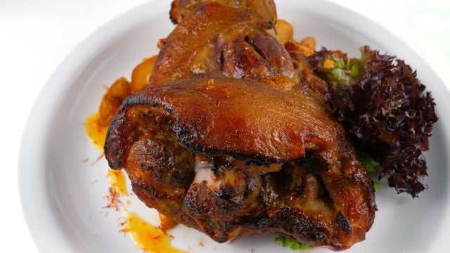 Ham hock or pork knuckle with potatoes and vegetables, served in Restaurant or Pub, loop, 4K, ProRes codec, 422 HQ, ISO 100