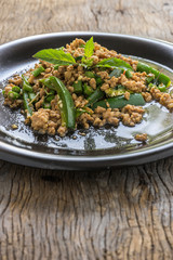 stir fried minced pork with basil in black dish. thai popular street food