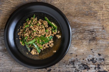 stir fried minced pork with basil in black dish. thai popular street food