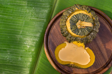 egg custard in bowl from pumpkin on banana leaf. thai local dessert style