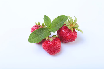 Fresh strawberries and mint leaves isolated on white background. Selective focus.