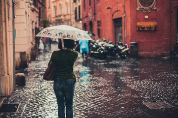 Woman under umbrella in heavy rain