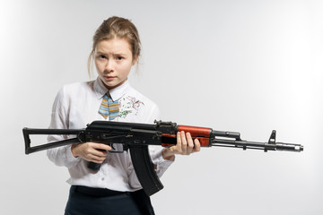 Girl with a frightened look with a Kalashnikov in his hand. Isolated