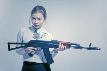 Girl with a frightened look with a Kalashnikov in his hand. Isolated