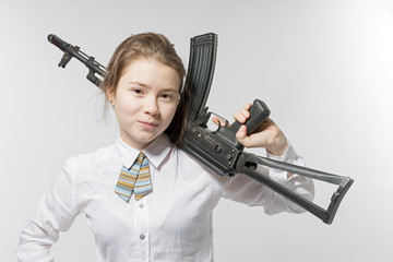Girl smiling with Kalashnikov in hand. Isolated