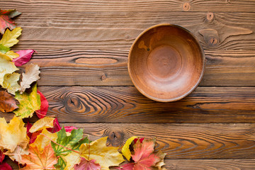 clay plate on autumn decorated wooden table,  top view - 172317001