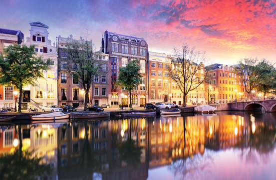 Sunset city view of Amsterdam, the Netherlands with Amstel river