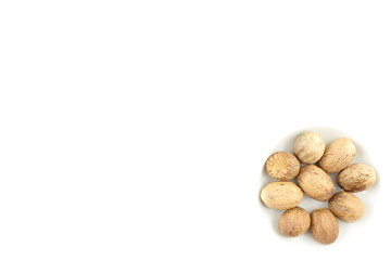 nutmeg seeds in a small white bowl