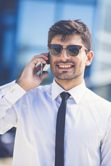 The smile businessman in sunglasses phone