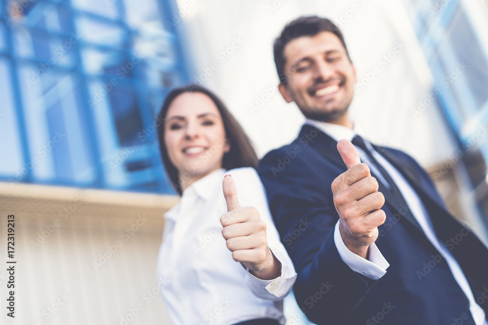 Wall mural the happy business man and woman thumb up