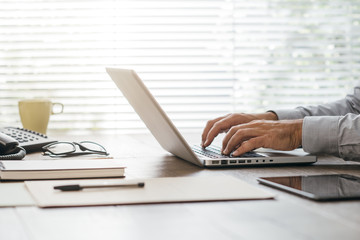 Corporate businessman working with a laptop