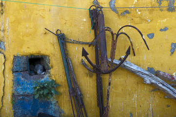 rusty anchors and yellow wall