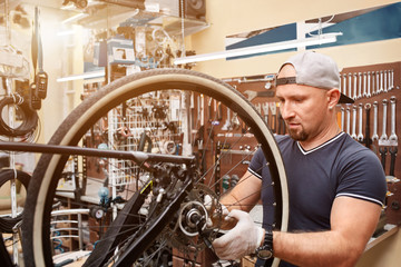 Mechanic repairing a mountain bike in a workshop