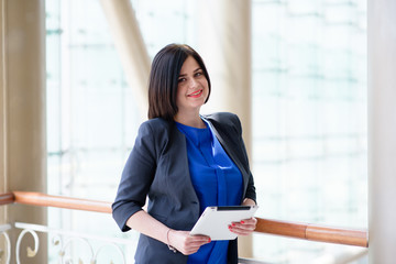 Business woman working with a laptop and a tablet.