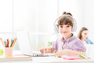 Cute girl connecting with a laptop