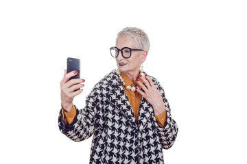 Stylish old woman in glassesmakes selfie isoladed on white.