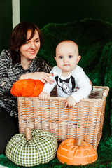 Mother plays with little son in the basket