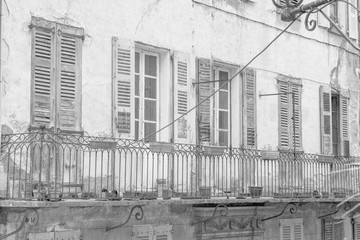 Old balcony in Entrevaux a village in the Haute Provence, France in black and white