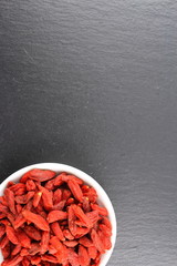 dried goji berries in a small white bowl